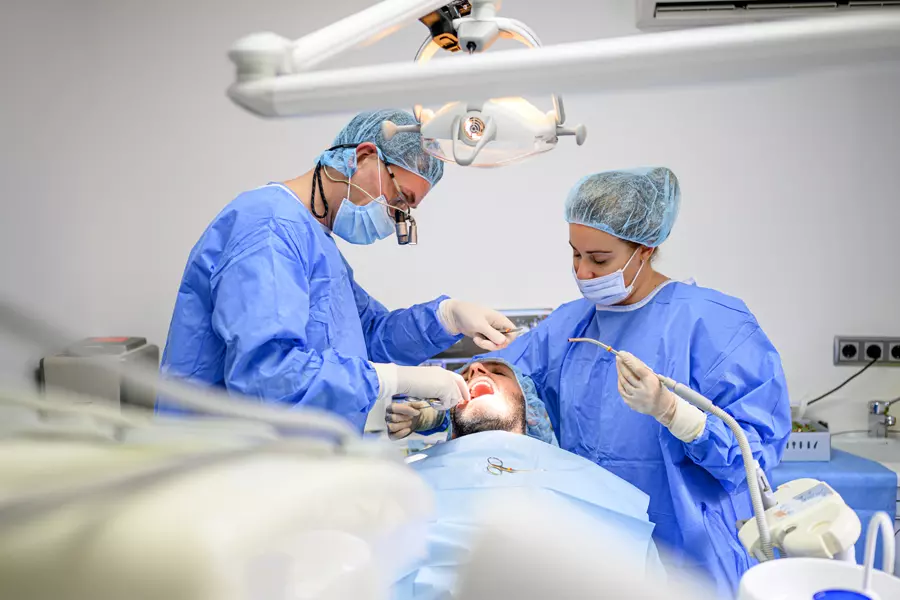 dental-surgeon-and-assistant-work-putting-dental-i-2026-01-05-01-03-28-utc.webp